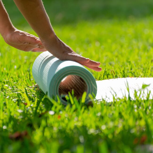 closeup-of-hands-rolling-yoga-mat-in-a-green-meado-2026-03-17-07-24-26-utc closeup-of-hands-rolling-yoga-mat-in-a-green-meado-2026-03-17-07-24-26-utc